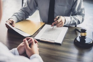 Closeup of the hands of a sex crime lawyer in Delaware County and their client discussing legal options.
