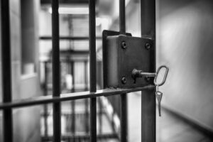 prison cell with a key in the grate