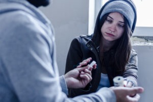 woman buying drugs from a dealer