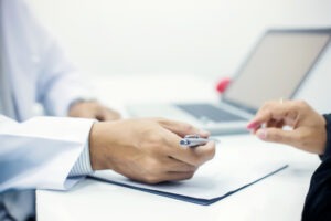 A woman talks to a lawyer in his office. They discuss the difference between unlawful sexual conduct with a minor and statutory rape in Ohio.