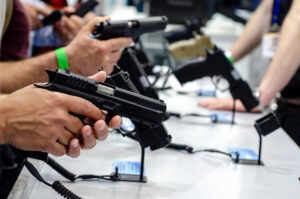 A hand holding a gun at a gun show. Does Ohio Have high gun crime?